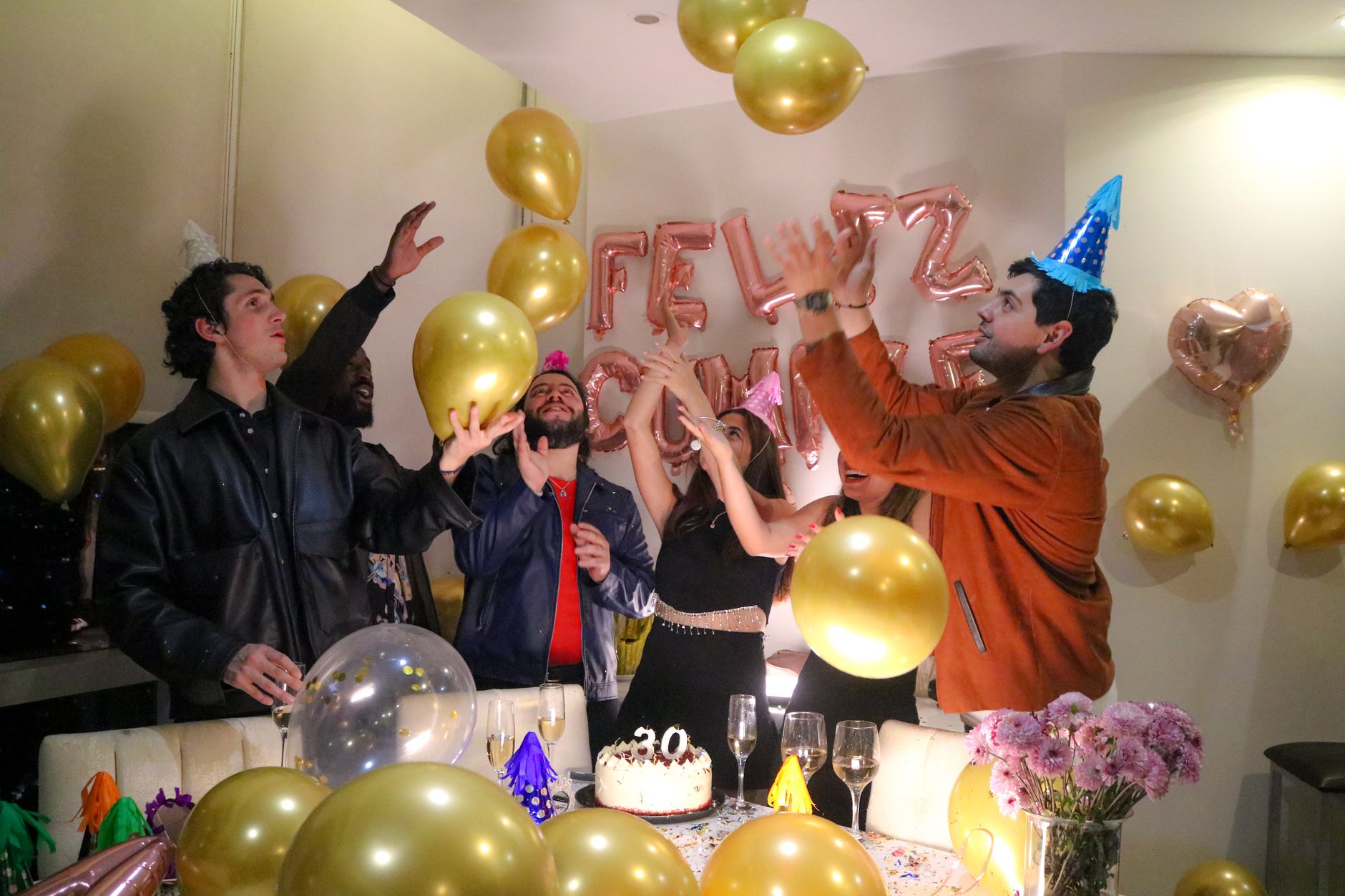 joyful birthday celebration with balloons and friends