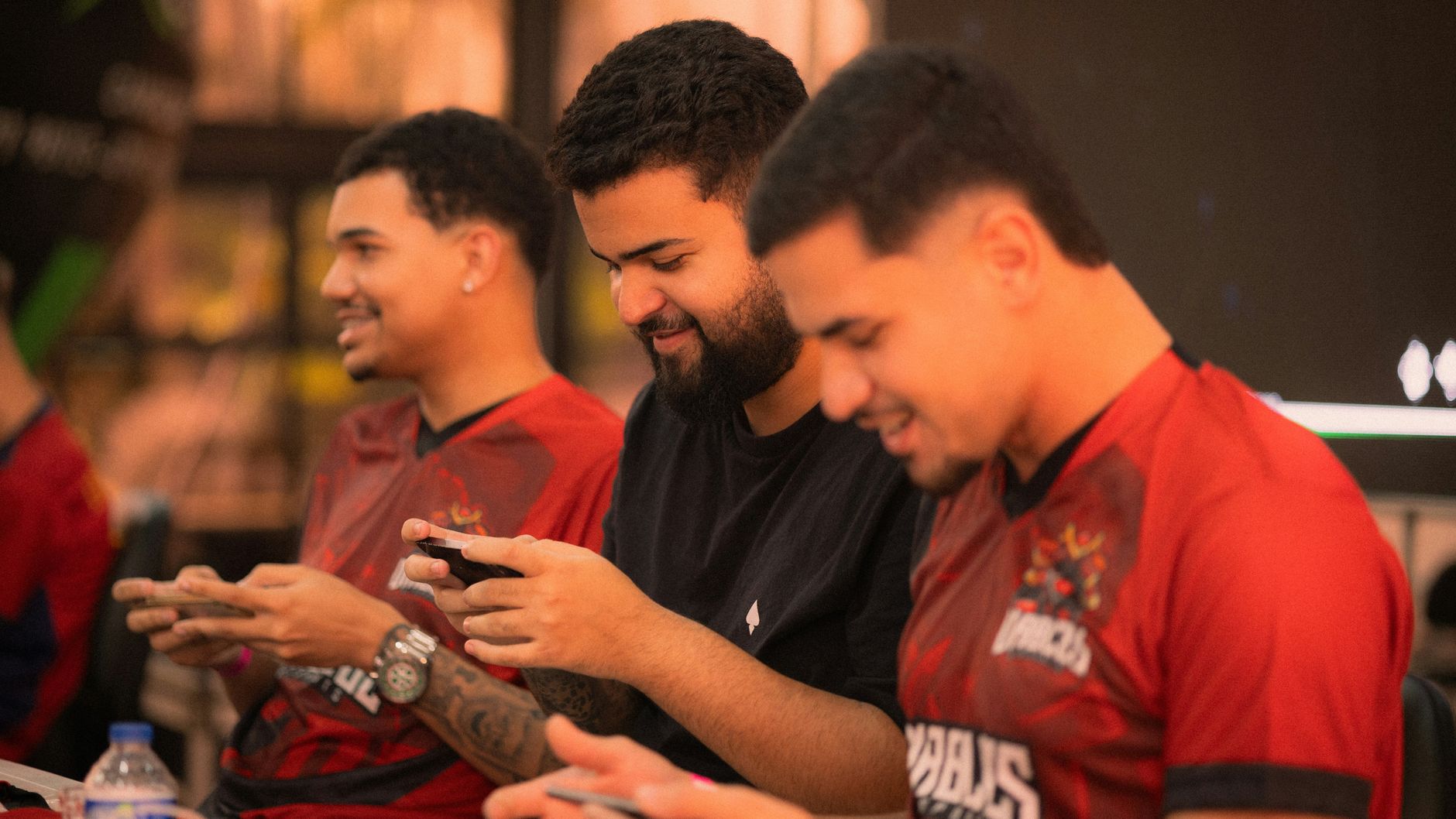 young men engaged in mobile gaming tournament