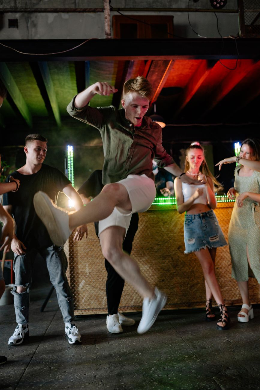 a man in white shorts dancing in the middle