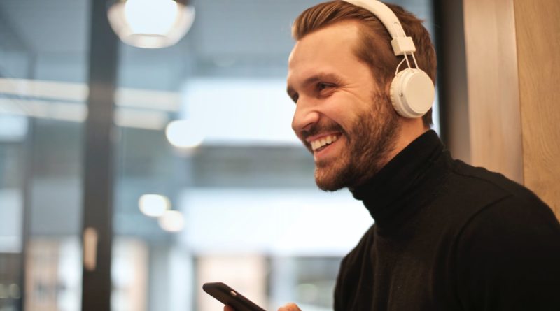 man wearing white headphones listening to music
