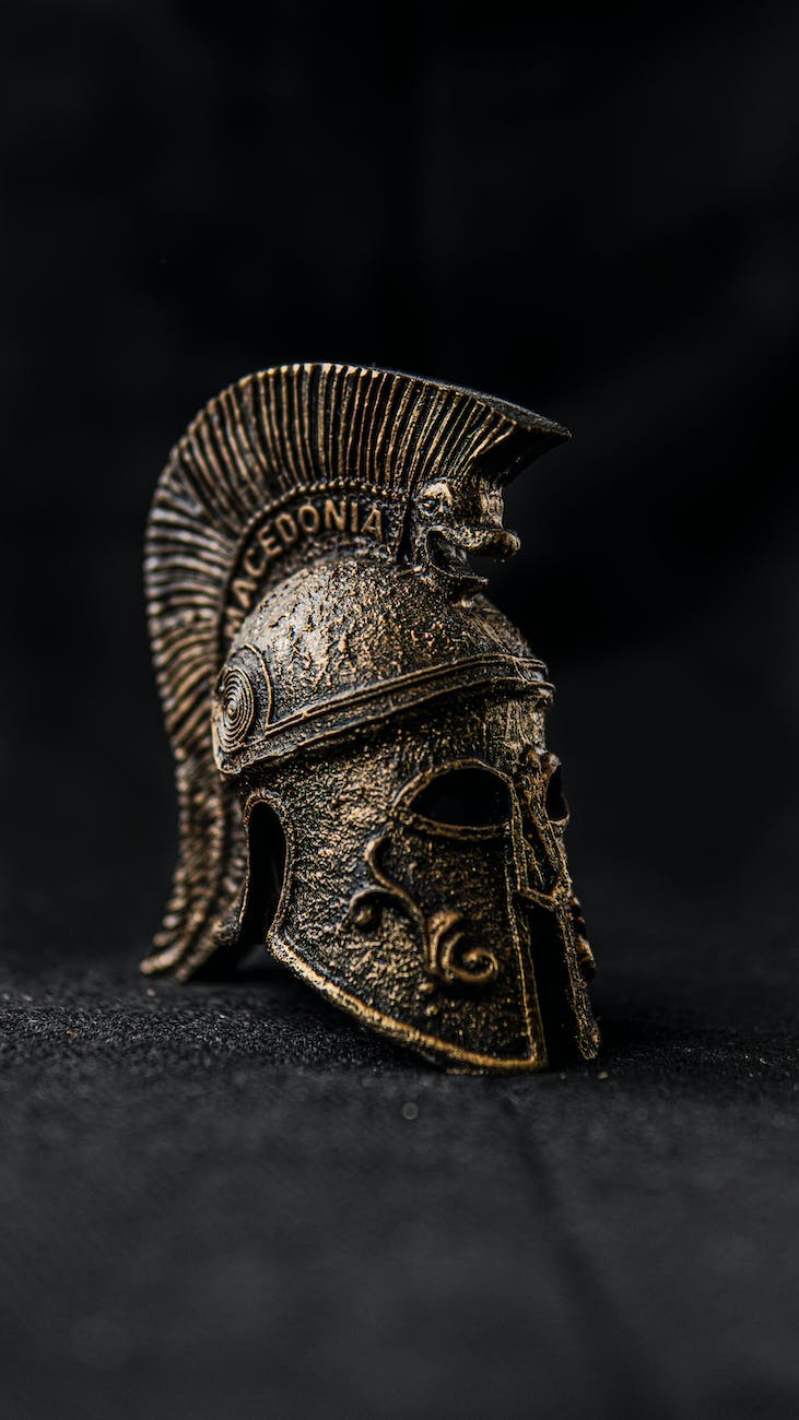 old spartan helmet with ornament on black background