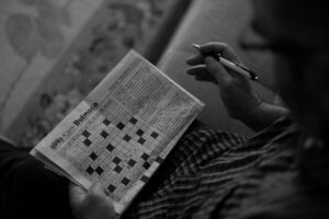 a person solving a crossword puzzle