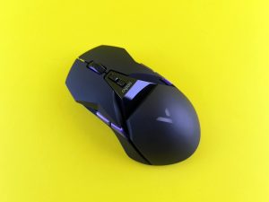 black gaming mouse on yellow background