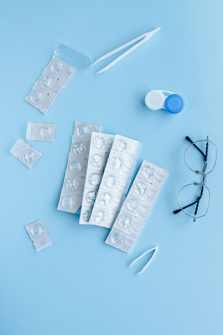 white and blue contact lens container on blue table