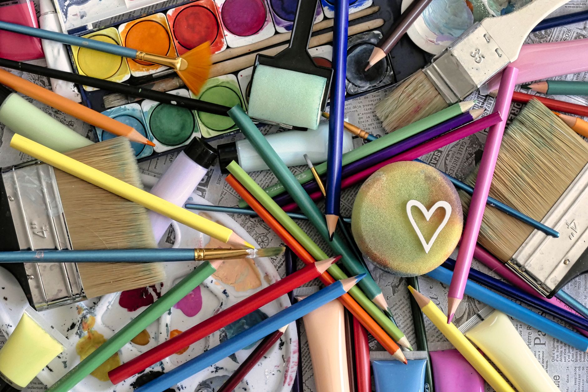 colorful art supplies jumble with heart motif