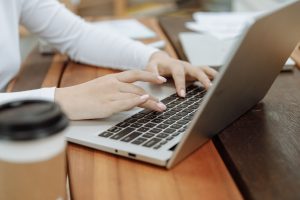 woman typing on laptop