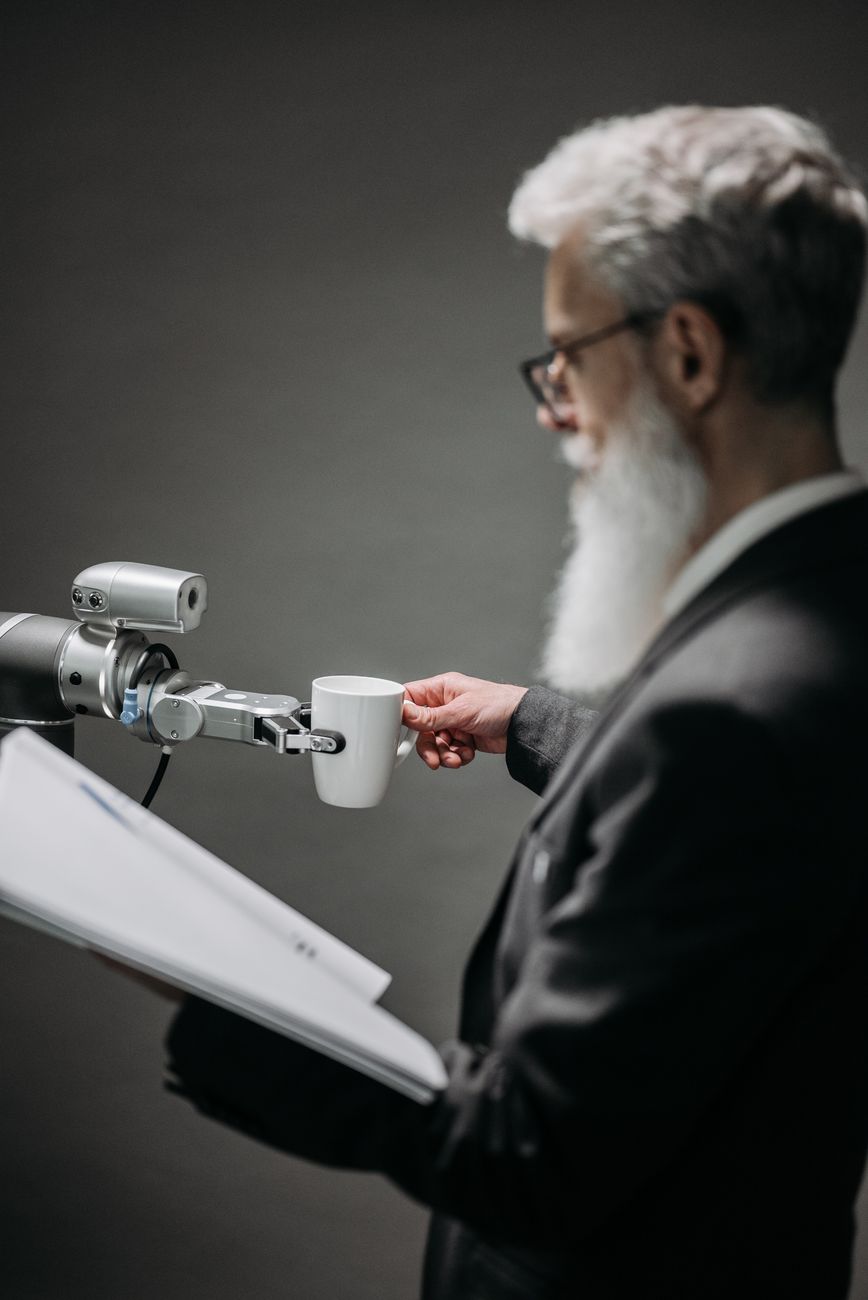 a robot holding a white cup